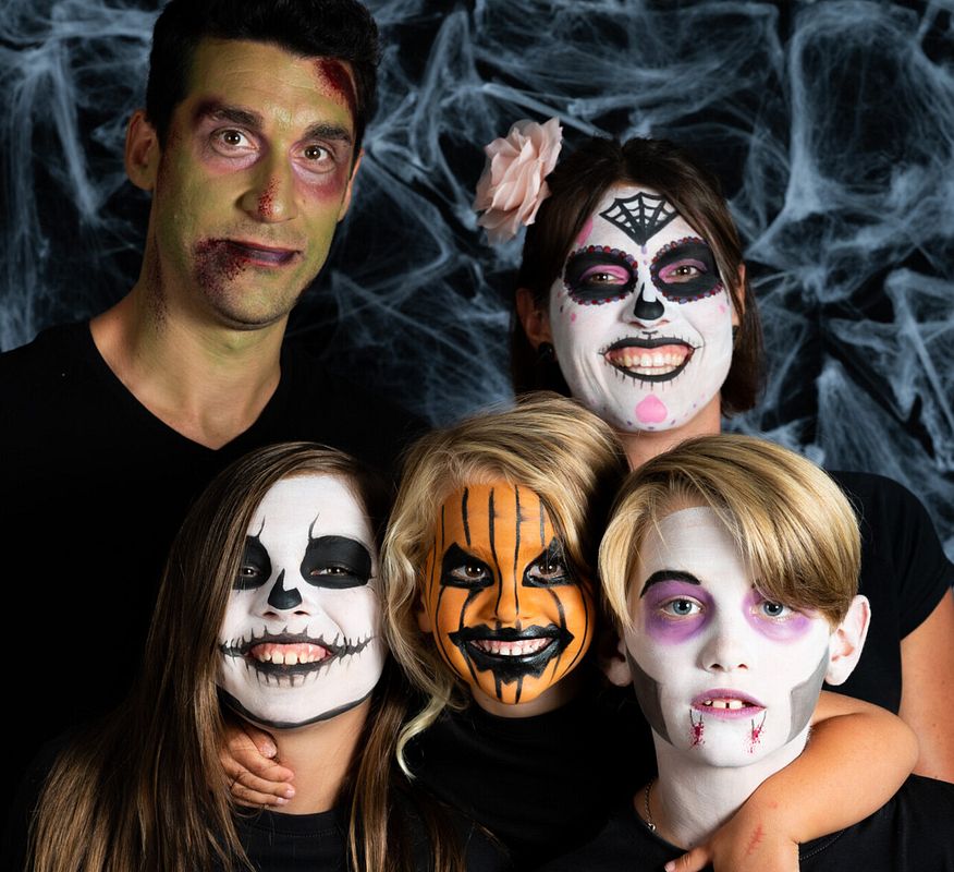 Familie geschminkt als Vampir, Kürbis, Sklett, Frankenstein und mexikanischer Calacas